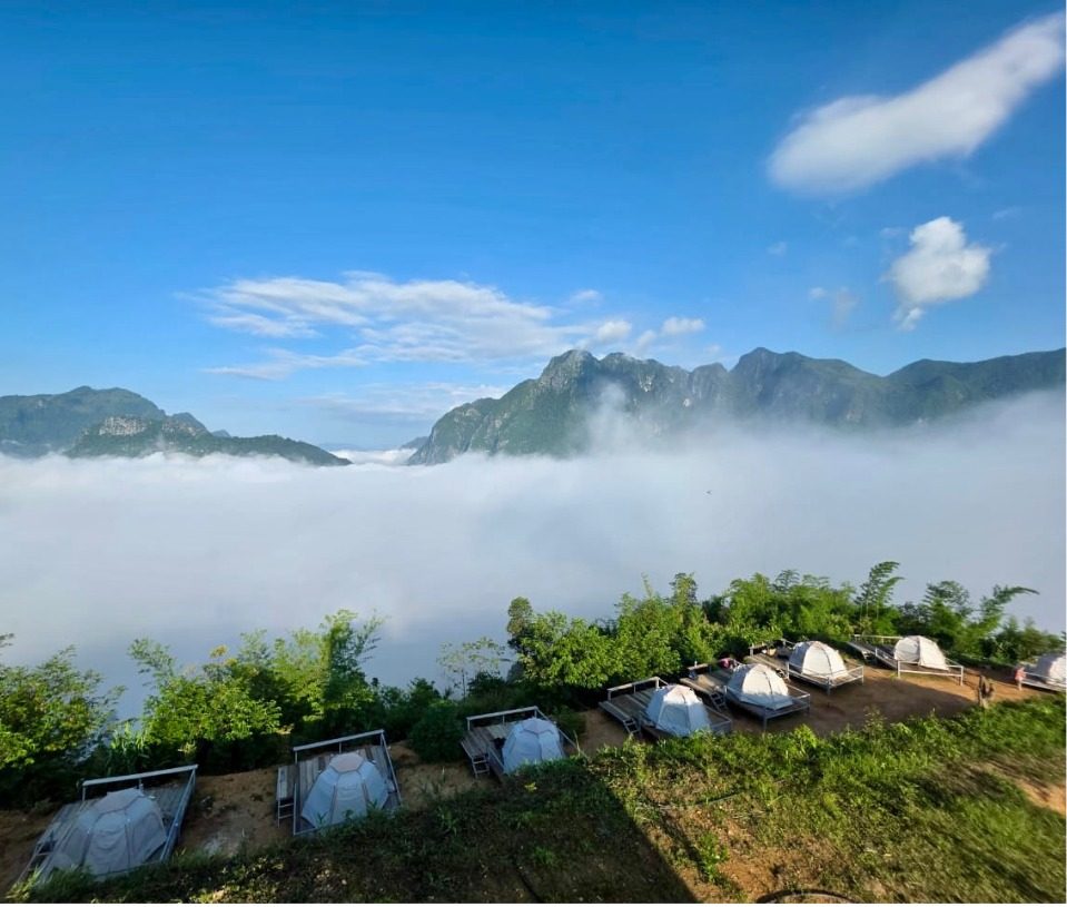Wide view of camp tents above the clouds