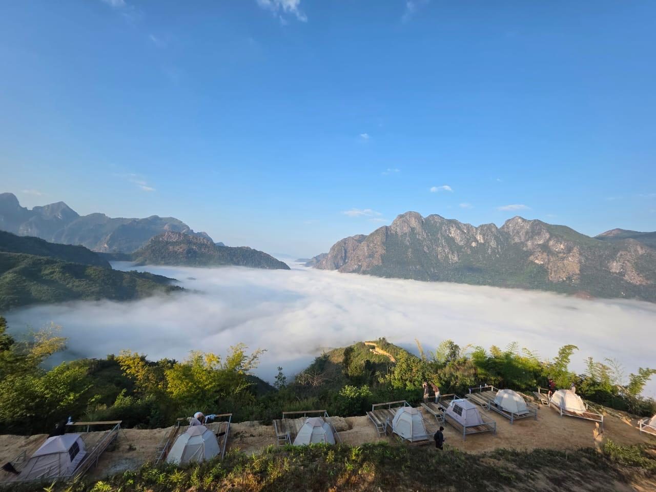 Tents above a sea of clouds at sunrise