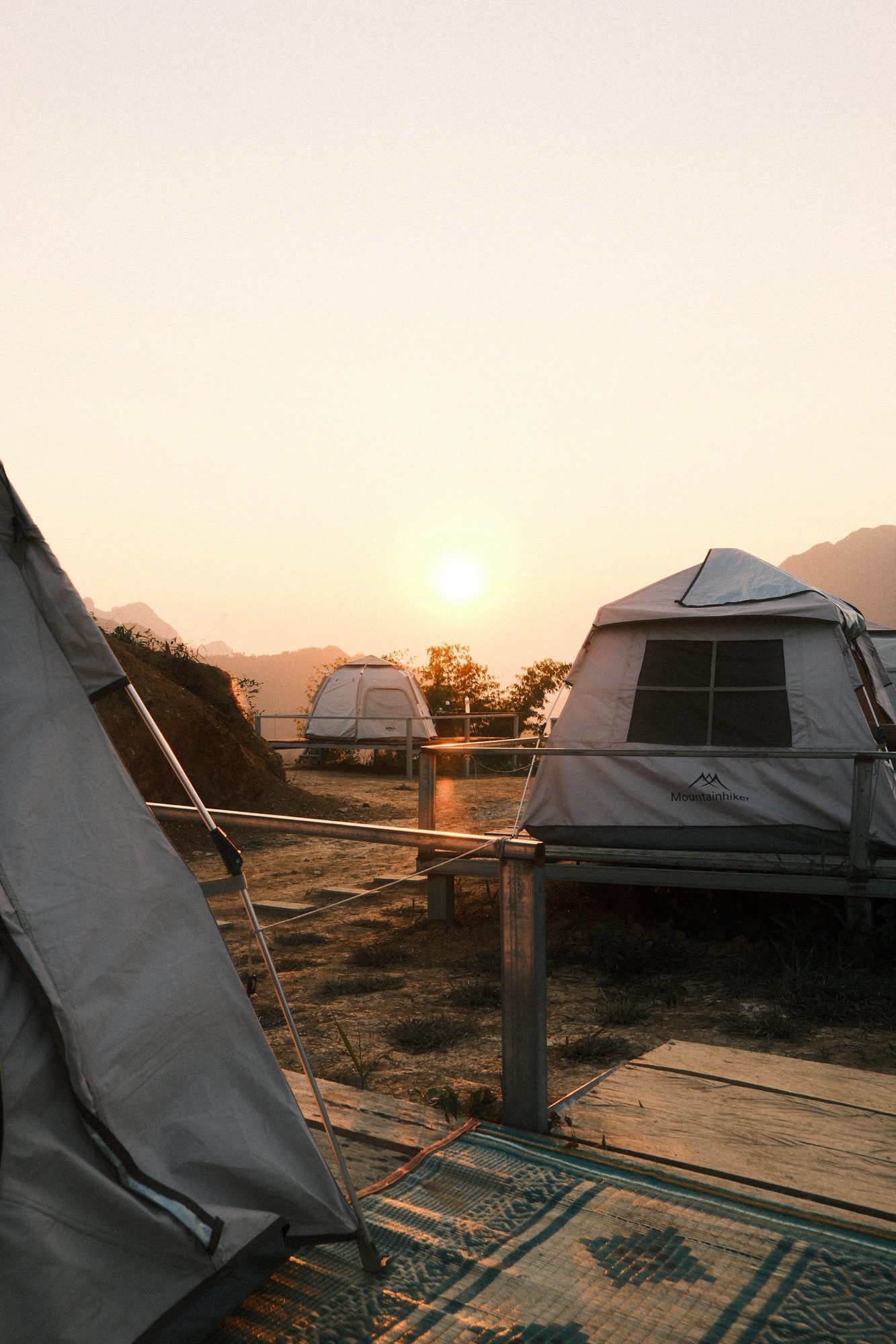 Sun setting behind a camping tent